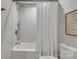 Bathroom featuring a shower-tub combo with white tile surround and gold fixtures at 1420 Columbus St, Albemarle, NC 28001