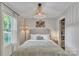 Bright bedroom with a large window, stylish woven lighting, and a gray upholstered bed at 1420 Columbus St, Albemarle, NC 28001