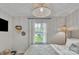 Bright bedroom with a window overlooking the landscaped yard, complemented by unique decor at 1420 Columbus St, Albemarle, NC 28001
