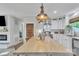 Bright kitchen featuring a large island, white cabinets, stainless steel appliances, and unique wooden doors at 1420 Columbus St, Albemarle, NC 28001