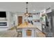 Open kitchen with a butcher block island, stainless steel appliances, and decorative pendant lights at 1420 Columbus St, Albemarle, NC 28001