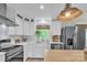 Kitchen with white cabinets, subway tile backsplash, stainless steel appliances, and a bright window at 1420 Columbus St, Albemarle, NC 28001