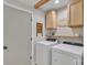 Well-lit laundry room featuring a washer, dryer, shelving and overhead cabinets at 1420 Columbus St, Albemarle, NC 28001