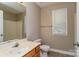 This bathroom provides a single sink vanity with wood cabinets, a shower and a window at 1930 Manning Pl, Rock Hill, SC 29730