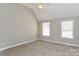 Spacious bedroom featuring a ceiling fan, vaulted ceiling, two windows and neutral carpeting at 1930 Manning Pl, Rock Hill, SC 29730