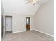 Bright bedroom featuring neutral carpet, vaulted ceiling and two doors; one leading to a bathroom at 1930 Manning Pl, Rock Hill, SC 29730