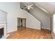 Open-concept living room featuring wood floors, a staircase, and seamless transition to other rooms at 1930 Manning Pl, Rock Hill, SC 29730