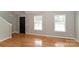 Bright living room with hardwood floors, two windows, neutral paint, and staircase to the second floor at 1930 Manning Pl, Rock Hill, SC 29730