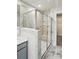 Bathroom with modern marble-tiled shower with glass door and built-in shelves and neutral tone vanity at 2009 Vinyasa Ln # Sts-44, Charlotte, NC 28215
