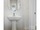 Elegant half bathroom showcasing a modern pedestal sink and clean design at 2009 Vinyasa Ln # Sts-44, Charlotte, NC 28215