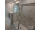 Well-lit bathroom highlighting a glass shower with white marble tiling at 2009 Vinyasa Ln # Sts-44, Charlotte, NC 28215
