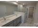 Bathroom featuring dual sinks, a walk-in shower and a walk-in closet at 2009 Vinyasa Ln # Sts-44, Charlotte, NC 28215