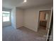 An inviting bedroom with neutral walls, soft carpet, and ample natural light from a nearby window at 2009 Vinyasa Ln # Sts-44, Charlotte, NC 28215