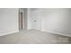 Bedroom featuring neutral walls and soft carpet with a large closet for plenty of storage space at 2009 Vinyasa Ln # Sts-44, Charlotte, NC 28215