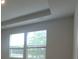 Bright bedroom featuring two windows and a tray ceiling design at 2009 Vinyasa Ln # Sts-44, Charlotte, NC 28215