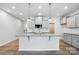 Bright kitchen with granite island, stainless appliances, and gray cabinets with lots of storage at 2009 Vinyasa Ln # Sts-44, Charlotte, NC 28215