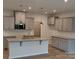 A modern kitchen features gray cabinets, stainless steel appliances, and granite countertops at 2009 Vinyasa Ln # Sts-44, Charlotte, NC 28215