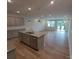 Modern kitchen and living area with hardwood floors, island, stainless appliances and granite countertops at 2009 Vinyasa Ln # Sts-44, Charlotte, NC 28215