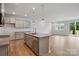 Open kitchen with granite countertops, stainless steel appliances, and wood floors with view to living space at 2009 Vinyasa Ln # Sts-44, Charlotte, NC 28215