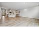 Spacious living room featuring light wood flooring, recessed lighting, and an open floor plan at 2009 Vinyasa Ln # Sts-44, Charlotte, NC 28215