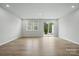 Bright living room with wood floors, recessed lighting, and sliding door access to the outdoor space at 2009 Vinyasa Ln # Sts-44, Charlotte, NC 28215