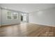 Spacious living room featuring wood floors, large windows, and access to the outside patio at 2009 Vinyasa Ln # Sts-44, Charlotte, NC 28215