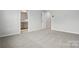 Bright bedroom showcasing an open doorway to a bathroom and neutral carpeting at 2009 Vinyasa Ln # Sts-44, Charlotte, NC 28215