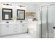 Bathroom featuring dual sinks, framed mirrors, and a glass enclosed shower at 20135 Northport Dr, Cornelius, NC 28031