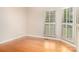 Bright bedroom with hardwood floors and natural light streaming through the shuttered windows at 20135 Northport Dr, Cornelius, NC 28031