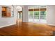 Bright living room with hardwood floors, large windows, and an open flow to other living spaces at 20135 Northport Dr, Cornelius, NC 28031