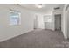 Bedroom highlighting neutral carpeting, a window with blinds, and a hallway at 2022 Mcdonald Dr, Stanfield, NC 28163