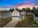 Charming two-story home featuring blue and white siding, a two-car garage, and a manicured front yard at 2022 Mcdonald Dr, Stanfield, NC 28163