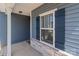 Exterior view of a blue home with a white-trimmed window, dark shutters, and stone accents at 2022 Mcdonald Dr, Stanfield, NC 28163