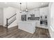 Bright kitchen featuring white cabinets, a center island, and stainless steel appliances at 2022 Mcdonald Dr, Stanfield, NC 28163
