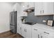 Bright kitchen features white cabinetry, stainless steel appliances, and sleek gray subway tile backsplash at 2022 Mcdonald Dr, Stanfield, NC 28163