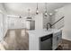 Open concept living area with hardwood floors, pendant lighting and staircase to the second floor at 2022 Mcdonald Dr, Stanfield, NC 28163