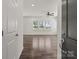 Bright living room with hardwood floors, three windows, and a ceiling fan at 2022 Mcdonald Dr, Stanfield, NC 28163