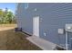 Image of the exterior side door, showcasing the home's blue siding and access point to the yard at 2022 Mcdonald Dr, Stanfield, NC 28163