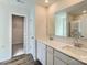 Bathroom featuring double sink vanity, framed mirror, luxury vinyl plank flooring and glass-enclosed shower at 2106 Columbidae Ln, Gastonia, NC 28052