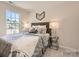 Cozy bedroom with a plush bed, stylish lamps, and natural light from the window at 2106 Columbidae Ln, Gastonia, NC 28052