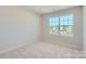 Inviting bedroom with neutral walls, carpet flooring and large window to allow natural light at 2106 Columbidae Ln, Gastonia, NC 28052