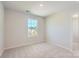 Cozy bedroom with plush carpeting, neutral paint, bright window and standard closet for ample storage at 2106 Columbidae Ln, Gastonia, NC 28052