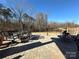 Stone patio featuring outdoor furniture and wooded backyard with a fence on a sunny day at 21110 Bank Fire Ln, Huntersville, NC 28078