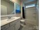 Bathroom featuring single sink vanity, modern fixtures, framed mirror and tiled shower/tub at 21110 Bank Fire Ln, Huntersville, NC 28078