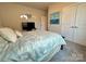 Cozy bedroom showcasing a comfortable bed, neutral walls, carpeted floor and double door closet at 21110 Bank Fire Ln, Huntersville, NC 28078