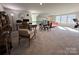 Expansive bonus room with work spaces, a seating area, and bright, natural lighting at 21110 Bank Fire Ln, Huntersville, NC 28078