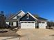 Attractive two-story home with a three-car garage, well-maintained lawn, and inviting curb appeal at 21110 Bank Fire Ln, Huntersville, NC 28078