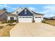 Charming two-story home featuring a two-car garage, well-manicured lawn, and beautiful landscaping at 21110 Bank Fire Ln, Huntersville, NC 28078