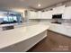 Bright kitchen with white cabinets, stainless steel appliances, a large island, and hardwood floors at 21110 Bank Fire Ln, Huntersville, NC 28078