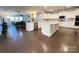 Open-concept kitchen and living area with white cabinets, a large island, and stainless steel appliances at 21110 Bank Fire Ln, Huntersville, NC 28078